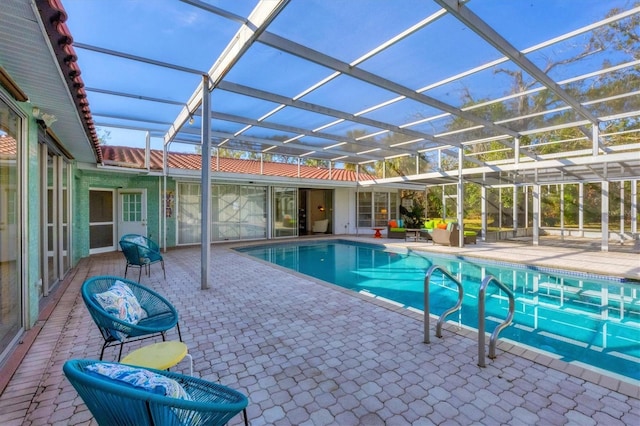 view of pool with a patio and glass enclosure