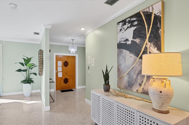 foyer entrance featuring crown molding and a notable chandelier