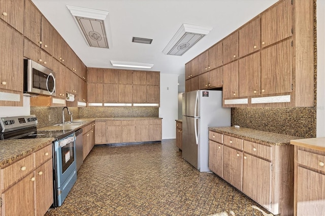 kitchen with stainless steel appliances, tasteful backsplash, and sink