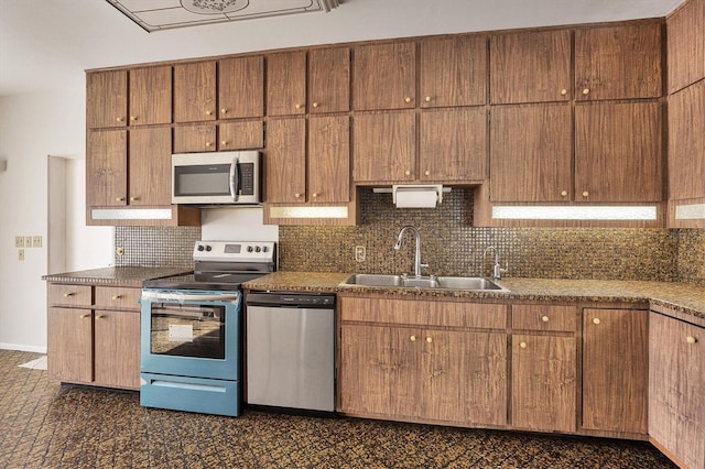 kitchen featuring tasteful backsplash, sink, and appliances with stainless steel finishes