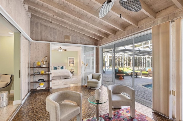 interior space with ceiling fan, wooden ceiling, and vaulted ceiling with beams