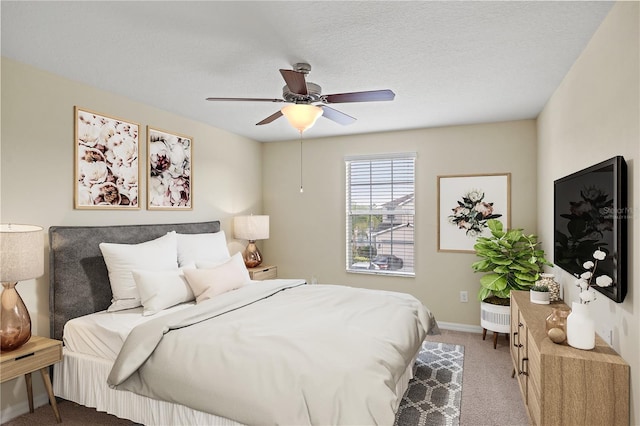 bedroom with carpet flooring, ceiling fan, and a textured ceiling