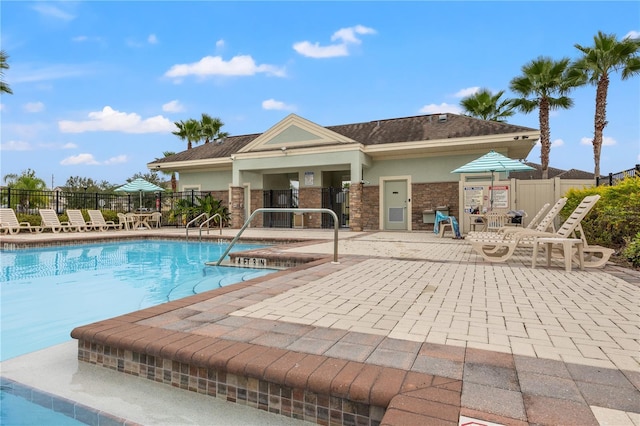 view of swimming pool with a patio and a hot tub