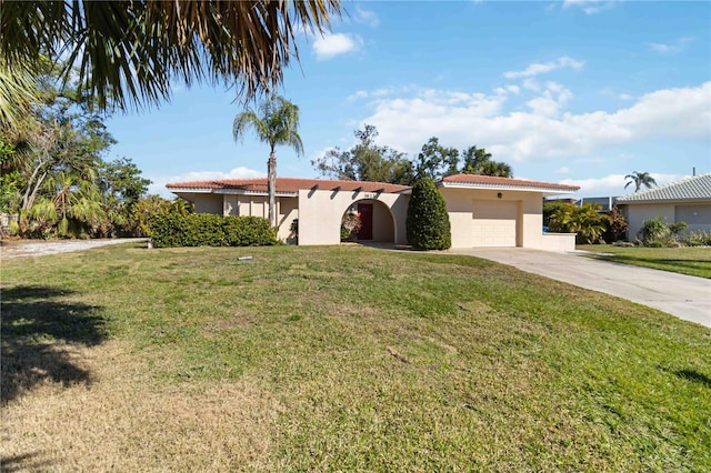 view of front of house with a garage and a front lawn