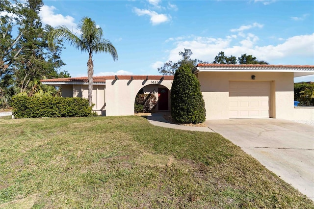 view of front of property with a garage and a front lawn