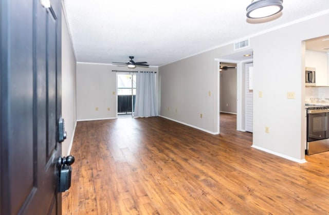 unfurnished living room with hardwood / wood-style flooring, ceiling fan, and ornamental molding