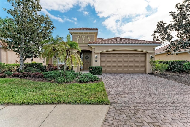 mediterranean / spanish home with a garage and a front yard