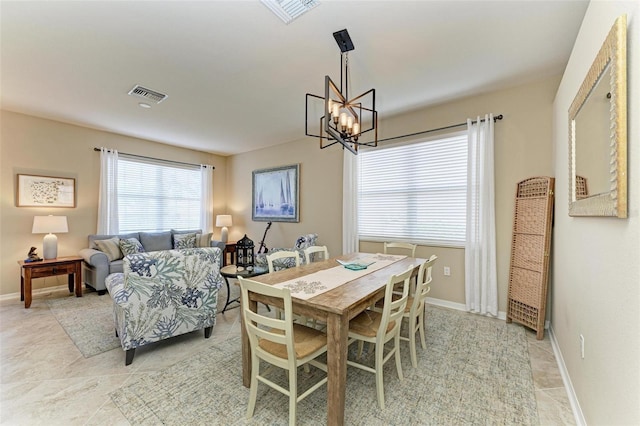 dining space with a notable chandelier