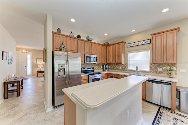 kitchen featuring decorative backsplash, stainless steel appliances, sink, light tile patterned floors, and a kitchen island