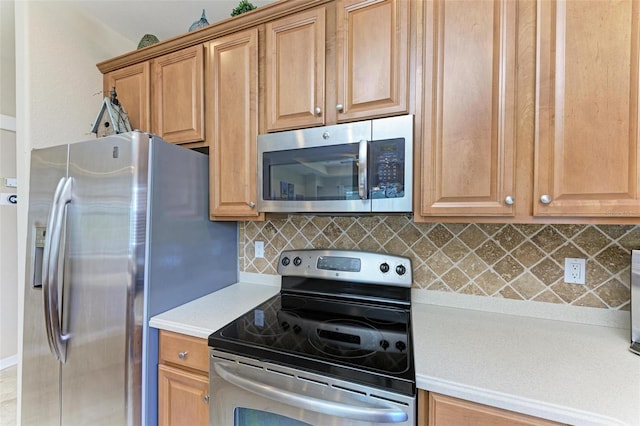 kitchen featuring appliances with stainless steel finishes and tasteful backsplash