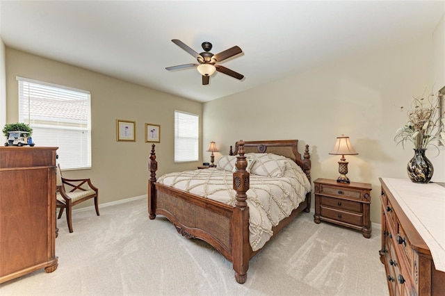 bedroom featuring light colored carpet and ceiling fan