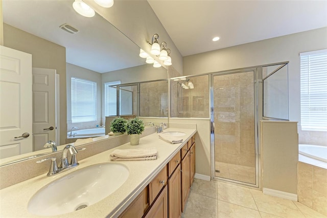 bathroom featuring vanity, tile patterned flooring, and plus walk in shower