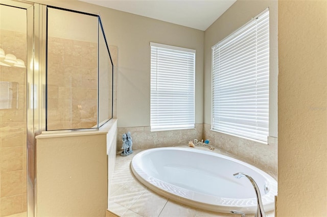 bathroom with plenty of natural light and shower with separate bathtub