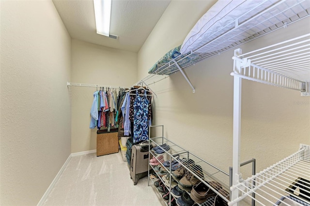 walk in closet featuring carpet