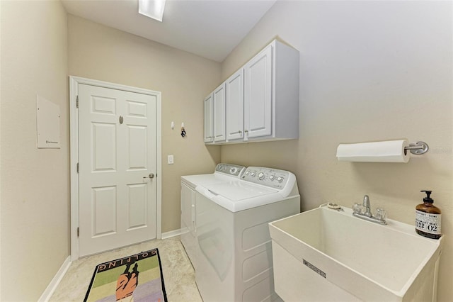 clothes washing area featuring cabinets, separate washer and dryer, and sink