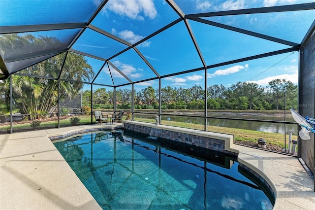 view of swimming pool with a water view, glass enclosure, and a patio area