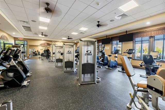 workout area with a drop ceiling and ceiling fan