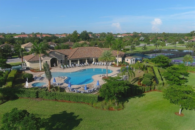 view of swimming pool with a yard, a patio, and a hot tub