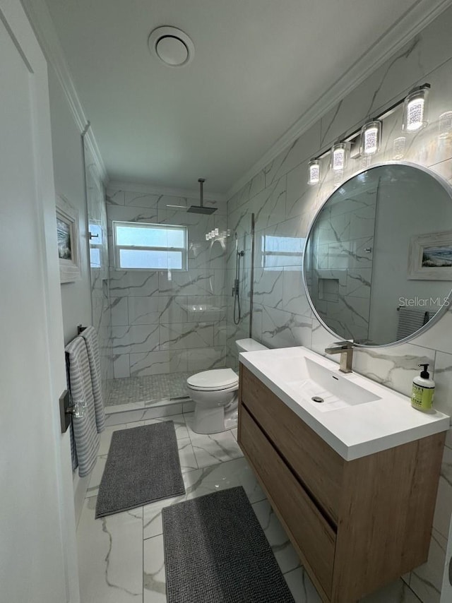 bathroom featuring crown molding, tiled shower, toilet, vanity, and tile walls