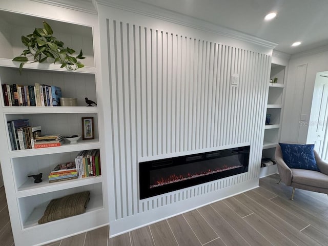 details featuring hardwood / wood-style floors, built in shelves, and crown molding