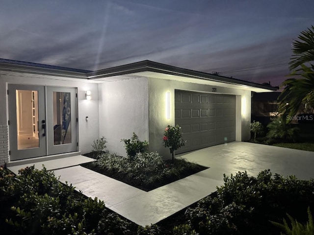 single story home with french doors and a garage