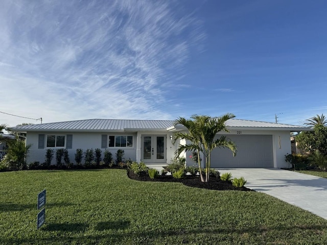 single story home with french doors, a garage, and a front lawn