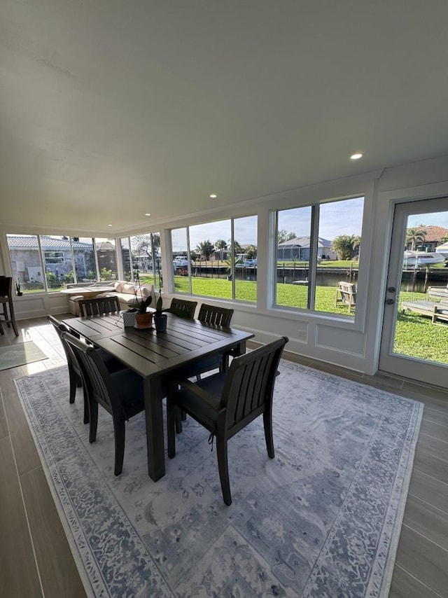 dining space featuring wood-type flooring and plenty of natural light