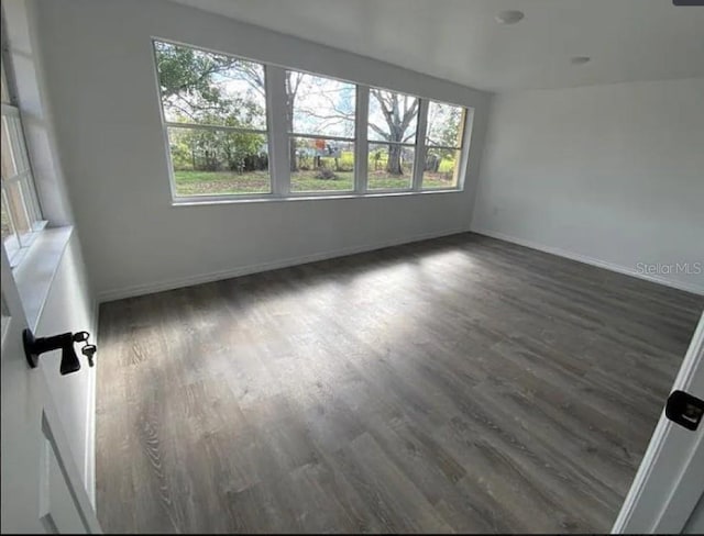 spare room with dark hardwood / wood-style flooring