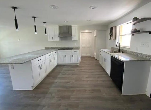 kitchen with kitchen peninsula, sink, black appliances, wall chimney range hood, and white cabinets