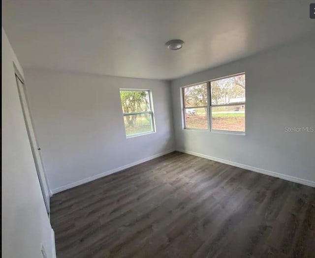 unfurnished room featuring dark hardwood / wood-style flooring