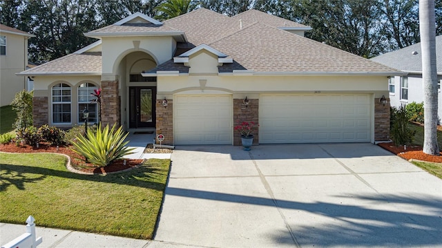 view of front of property featuring a front yard and a garage