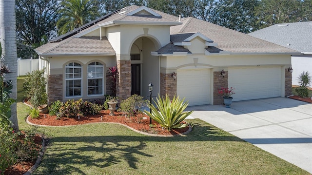 view of front facade with a front yard and a garage