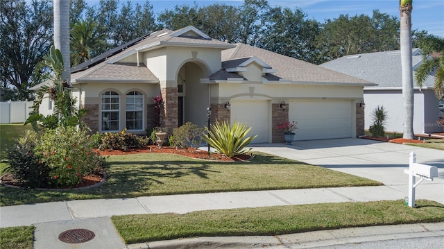 view of front of property featuring solar panels, a garage, and a front lawn