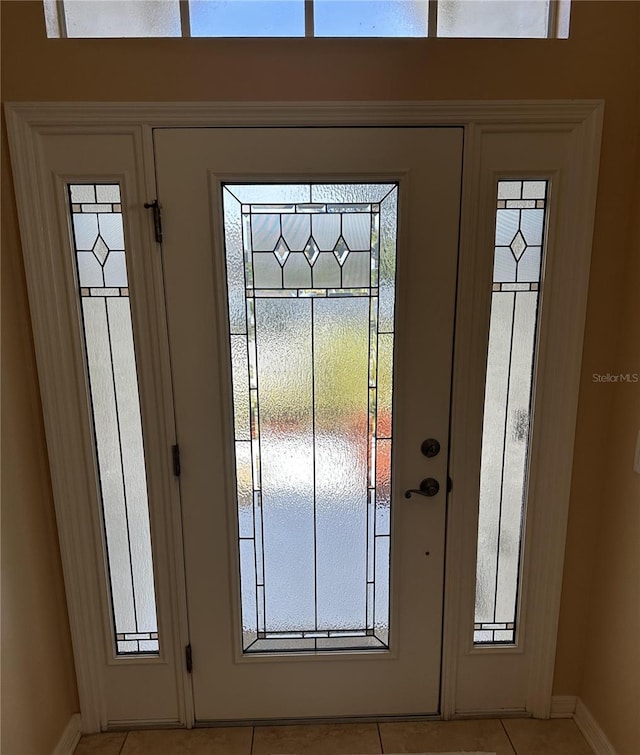 tiled entrance foyer featuring plenty of natural light