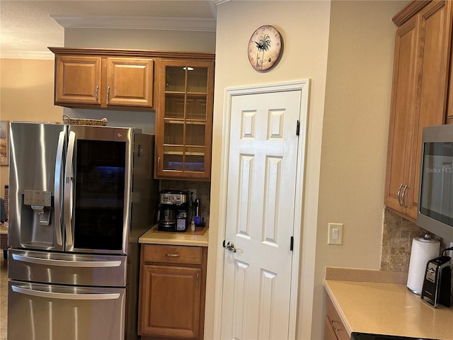 3439 101st Ave E, Parrish, FL 34219 - kitchen featuring stainless steel appliances, crown molding, light countertops, brown cabinets, and decorative backsplash