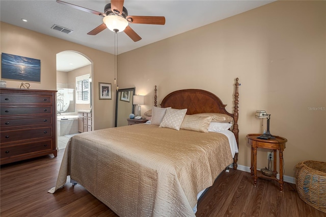 3439 101st Ave E, Parrish, FL 34219 - bedroom with wood finished floors, arched walkways, connected bathroom, and a ceiling fan