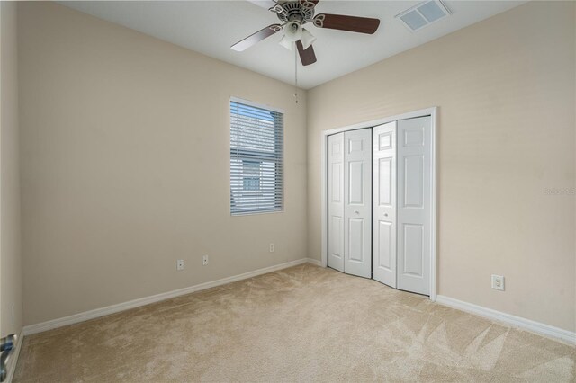 3439 101st Ave E, Parrish, FL 34219 - unfurnished bedroom featuring light colored carpet, a closet, and a ceiling fan