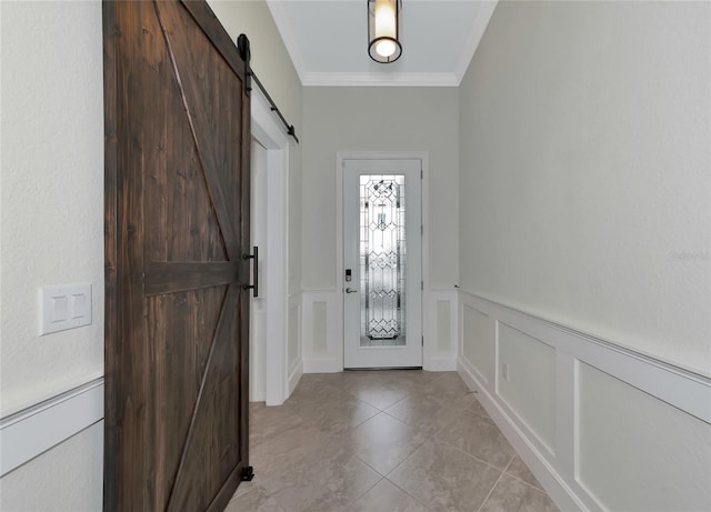 entryway featuring light tile patterned floors, a barn door, and crown molding