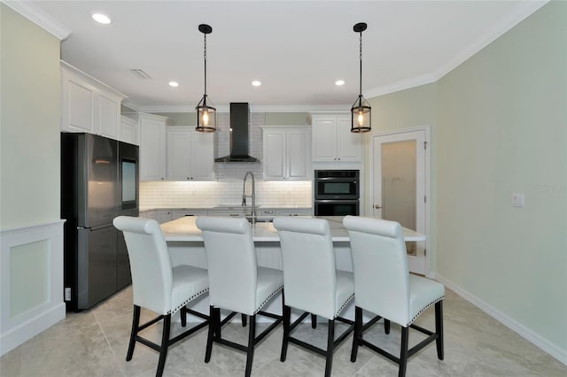 kitchen with a center island with sink, stainless steel fridge, wall chimney range hood, double oven, and white cabinets