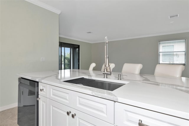 kitchen with white cabinets, crown molding, light stone countertops, a healthy amount of sunlight, and sink