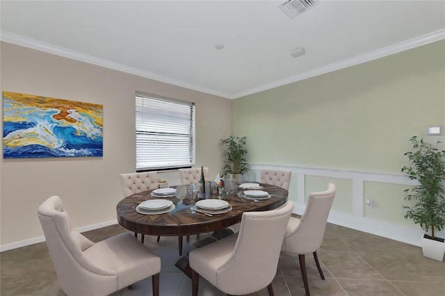 tiled dining area featuring ornamental molding