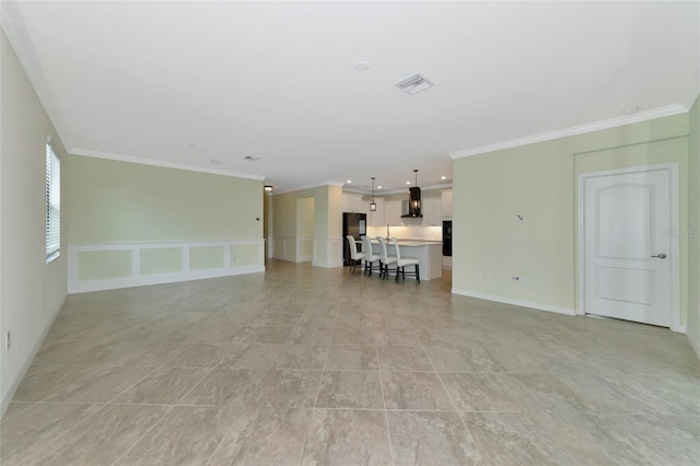 unfurnished living room with ornamental molding