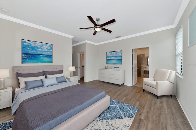 bedroom featuring crown molding, ensuite bath, ceiling fan, and hardwood / wood-style flooring