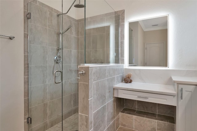 bathroom featuring an enclosed shower, vanity, and ornamental molding