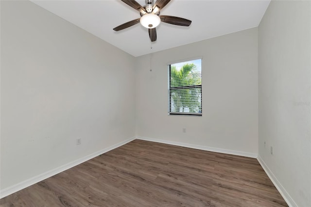 empty room featuring ceiling fan and dark wood-type flooring