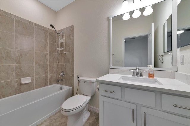 full bathroom with vanity, tile patterned flooring, tiled shower / bath combo, and toilet