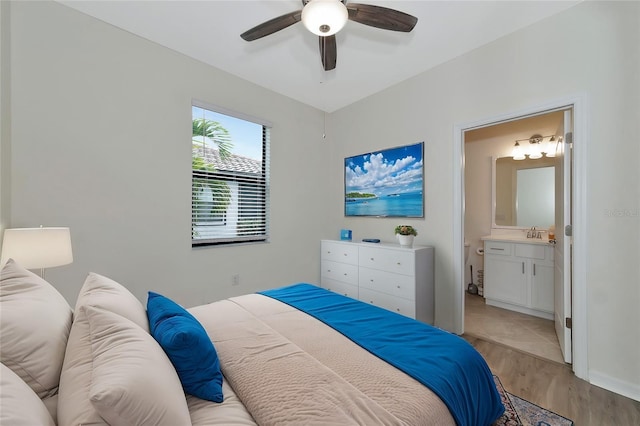 bedroom with sink, ensuite bath, ceiling fan, and light hardwood / wood-style floors