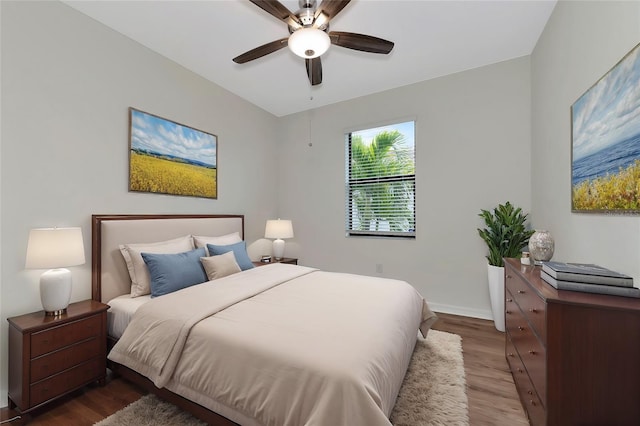 bedroom with ceiling fan and dark hardwood / wood-style floors