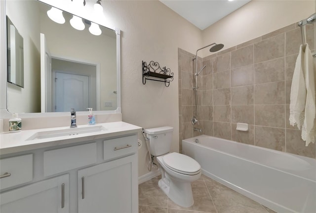 full bathroom featuring tile patterned flooring, toilet, vanity, and tiled shower / bath