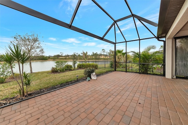 view of patio / terrace with a lanai and a water view